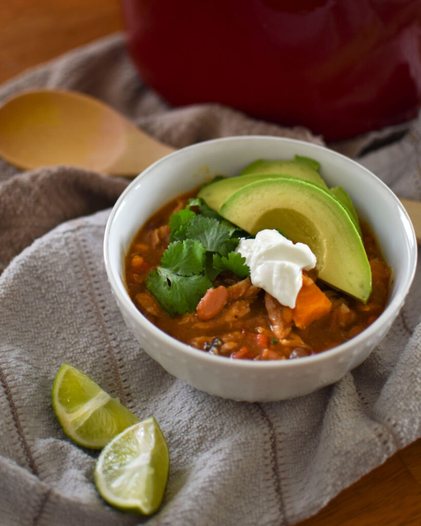 Bowl with soup, avocado, limes